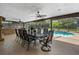 Screened outdoor dining area with seating for ten and a view of the pool and backyard at 795 Superior St, Deltona, FL 32725