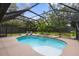 Screened-in pool area with stone accents and lush landscaping at 795 Superior St, Deltona, FL 32725