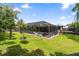 Large, screened-in pool area surrounded by lush green grass and trees at 795 Superior St, Deltona, FL 32725