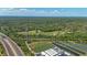 Wide aerial view of ponds, highway, and lush trees in a sprawling landscape at 800 Hidden Oaks Ln, Oak Hill, FL 32759