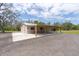 The barn's covered equipment area offers easy access and ample space at 800 Hidden Oaks Ln, Oak Hill, FL 32759
