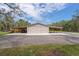The barn features covered parking and ample equipment storage at 800 Hidden Oaks Ln, Oak Hill, FL 32759