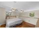 Large bedroom with hardwood floors, ceiling fans, and plenty of natural light at 800 Hidden Oaks Ln, Oak Hill, FL 32759