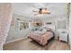 Cozy bedroom with a ceiling fan, natural lighting, and charming décor elements at 800 Hidden Oaks Ln, Oak Hill, FL 32759