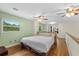 Expansive bedroom featuring hardwood floors, multiple ceiling fans, and abundant natural light at 800 Hidden Oaks Ln, Oak Hill, FL 32759
