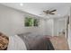 Bright bedroom with hardwood floors, ceiling fan, closet, and an ensuite bathroom at 800 Hidden Oaks Ln, Oak Hill, FL 32759