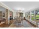 Bright dining room with beautiful views, decorative chandelier, and tile flooring at 800 Hidden Oaks Ln, Oak Hill, FL 32759