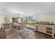 Dining room with large windows providing views of landscaped exterior at 800 Hidden Oaks Ln, Oak Hill, FL 32759