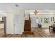 Inviting entryway with wooden stairs, modern lighting, and wood-look floors at 800 Hidden Oaks Ln, Oak Hill, FL 32759