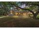 The exterior features a covered front porch and mature trees at 800 Hidden Oaks Ln, Oak Hill, FL 32759