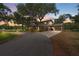 Charming home with a porte cochere and lush landscaping, nestled under mature trees at 800 Hidden Oaks Ln, Oak Hill, FL 32759