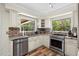 Bright kitchen featuring stainless steel appliances, granite countertops and hardwood flooring at 800 Hidden Oaks Ln, Oak Hill, FL 32759