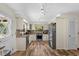 Well lit kitchen featuring stainless steel appliances, granite countertops and hardwood flooring at 800 Hidden Oaks Ln, Oak Hill, FL 32759
