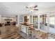 Bright kitchen with an island, wood floors and a view into a living room at 800 Hidden Oaks Ln, Oak Hill, FL 32759
