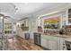 Bright kitchen with an island, wood floors, stainless steel appliances and granite countertops at 800 Hidden Oaks Ln, Oak Hill, FL 32759