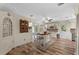 Bright kitchen with an island, wood floors, stainless steel appliances and white cabinets at 800 Hidden Oaks Ln, Oak Hill, FL 32759