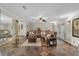 Spacious living room featuring tile flooring, natural light and a comfortable sectional at 800 Hidden Oaks Ln, Oak Hill, FL 32759