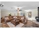 Spacious living room with tile floors, large couch, and fireplace at 800 Hidden Oaks Ln, Oak Hill, FL 32759