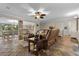 Spacious living room featuring stone floors, leather furniture, and a ceiling fan at 800 Hidden Oaks Ln, Oak Hill, FL 32759