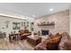 Inviting living room with a brick fireplace, leather furniture, and hardwood floors at 800 Hidden Oaks Ln, Oak Hill, FL 32759