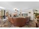 Open living room with tile floors, large couch, and fireplace at 800 Hidden Oaks Ln, Oak Hill, FL 32759