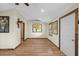 The open living room features wood floors, neutral walls and lots of natural light at 800 Hidden Oaks Ln, Oak Hill, FL 32759