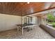 Spacious sunroom with a ping pong table and stone floors at 800 Hidden Oaks Ln, Oak Hill, FL 32759