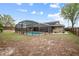 Expansive backyard with a screened pool, complemented by a well-maintained lawn and privacy fence at 808 Jutland St, Deltona, FL 32725
