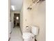Bathroom and toilet are situated adjacent to the laundry room at 808 Jutland St, Deltona, FL 32725