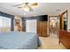 Bedroom with blue comforter, television, and view into the dining area at 808 Jutland St, Deltona, FL 32725