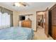 Bedroom featuring neutral carpet, ceiling fan and multiple wood paneled doors at 808 Jutland St, Deltona, FL 32725