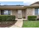 Inviting brick entryway featuring a covered porch, manicured hedge, and a walkway leading to the front door at 808 Jutland St, Deltona, FL 32725