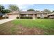 Charming single-story brick home featuring an attached garage and a well-maintained lawn with mature landscaping at 808 Jutland St, Deltona, FL 32725