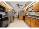 Bright kitchen with tiled flooring, granite countertops, and wooden cabinetry at 808 Jutland St, Deltona, FL 32725