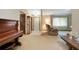 Bright and spacious living room featuring tile floors, a piano, and a large window with abundant natural light at 808 Jutland St, Deltona, FL 32725