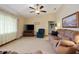 Cozy living room with a ceiling fan, comfortable sofa, and large windows providing ample natural light at 808 Jutland St, Deltona, FL 32725