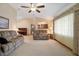 Expansive living room with vaulted ceiling, ceiling fan, and large windows providing ample natural light at 808 Jutland St, Deltona, FL 32725