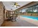 Enclosed patio featuring a ceiling fan and swimming pool in the backyard at 808 Jutland St, Deltona, FL 32725