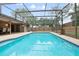 Inviting screened pool with pristine blue water and patio area, perfect for relaxation and entertainment at 808 Jutland St, Deltona, FL 32725