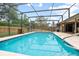 Backyard swimming pool enclosed by a screen with outdoor furniture at 808 Jutland St, Deltona, FL 32725