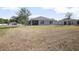Expansive backyard with lush lawn and view of the house at 811 Grand Park Ct, Deland, FL 32724