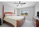 Bedroom with wooden bed frame, neutral walls, and a window view of the outdoors at 811 Grand Park Ct, Deland, FL 32724