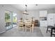 Cozy dining area adjacent to the kitchen, featuring a modern light fixture and sliding glass doors to the patio at 811 Grand Park Ct, Deland, FL 32724