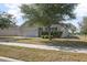 Charming home exterior featuring a well manicured front yard and a two car garage at 811 Grand Park Ct, Deland, FL 32724
