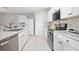 Well-appointed kitchen featuring granite countertops, stainless steel appliances, and ample cabinet space at 811 Grand Park Ct, Deland, FL 32724