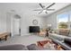 Comfortable living room featuring a ceiling fan and a view of the outdoors through a large window at 811 Grand Park Ct, Deland, FL 32724