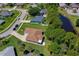 Aerial shot of the house showcasing the roof, backyard, and surrounding neighborhood with mature landscaping at 823 Wooddusk Dr, Port Orange, FL 32127