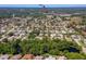 Aerial view of a residential neighborhood with lush trees and an arrow indicating the property's location near Publix at 823 Wooddusk Dr, Port Orange, FL 32127