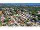 Aerial view of a neighborhood featuring tree-lined streets and a pond, highlighting the property's location at 823 Wooddusk Dr, Port Orange, FL 32127