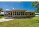 Rear exterior of home featuring screen patio, landscaped backyard and beautiful lawn at 823 Wooddusk Dr, Port Orange, FL 32127